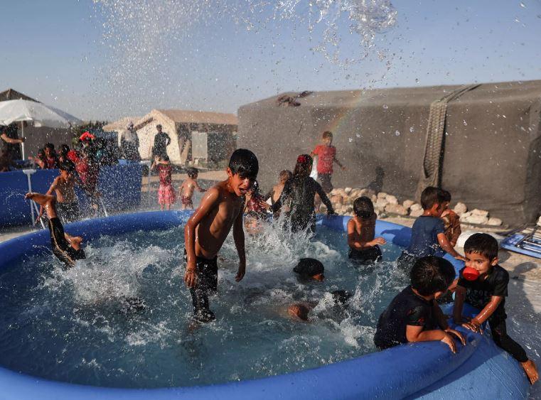 Mobile pools offer relief from heat to children in north Syria camps