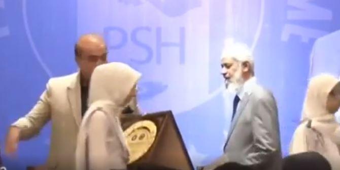 Dr Zakir Naik walks away from stage during an event in capital