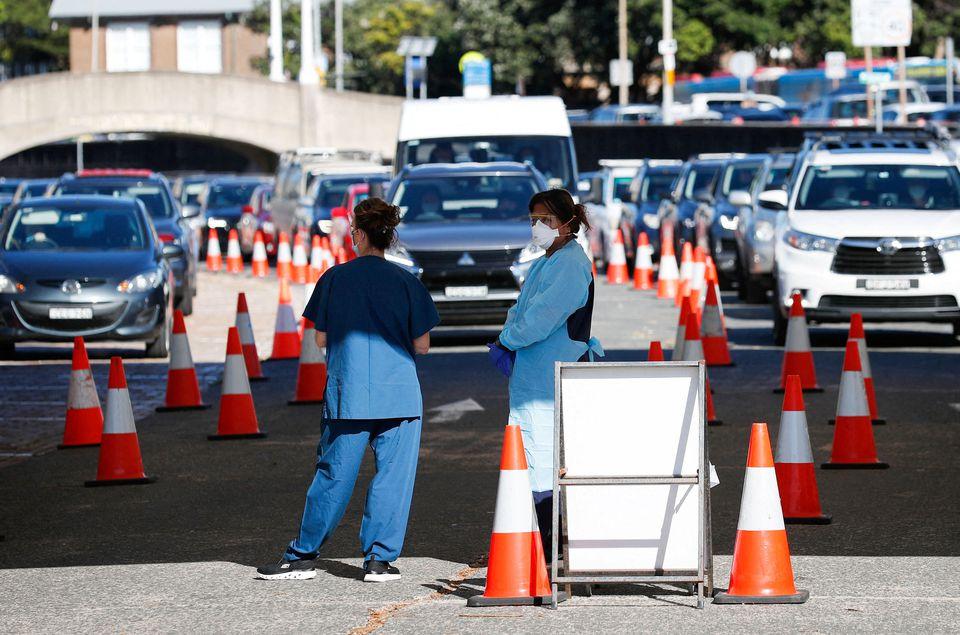 Australia treasurer tests positive for COVID-19 as daily cases soar past 100,000