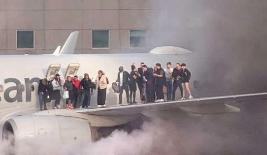 American Airlines plane catches fire on runway, evacuation ensues