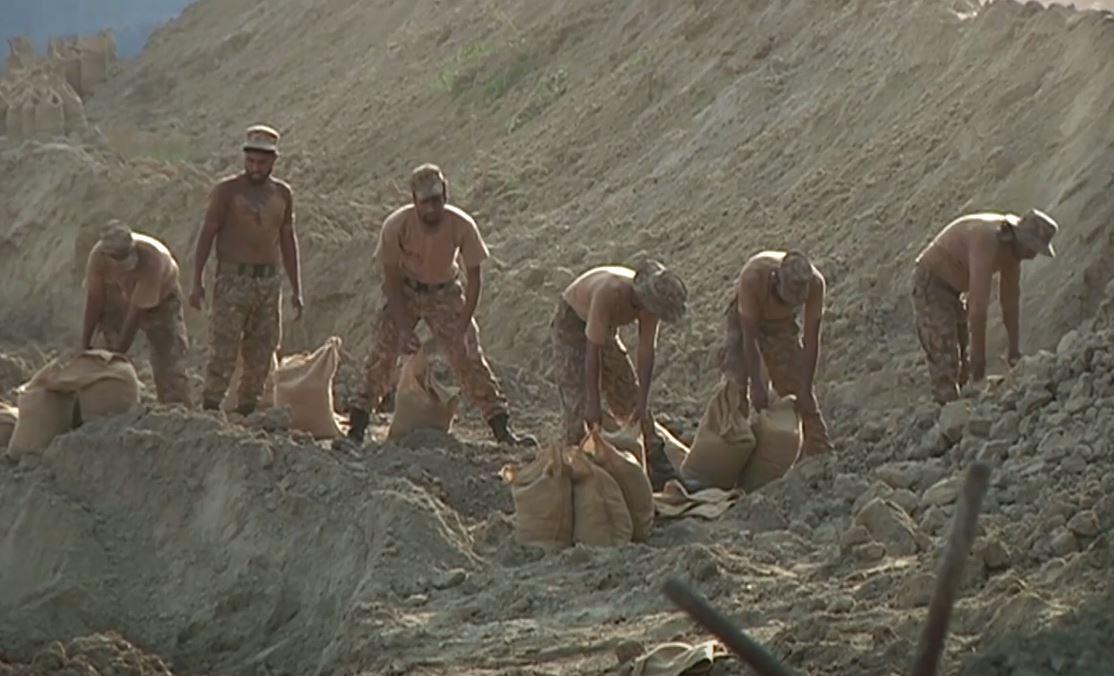 Pakistani authorities race to keep floodwaters out of vital power station that supplies millions