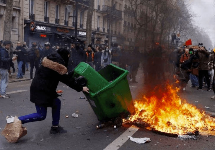 Embattled Macron heads to China, leaving burning Paris behind