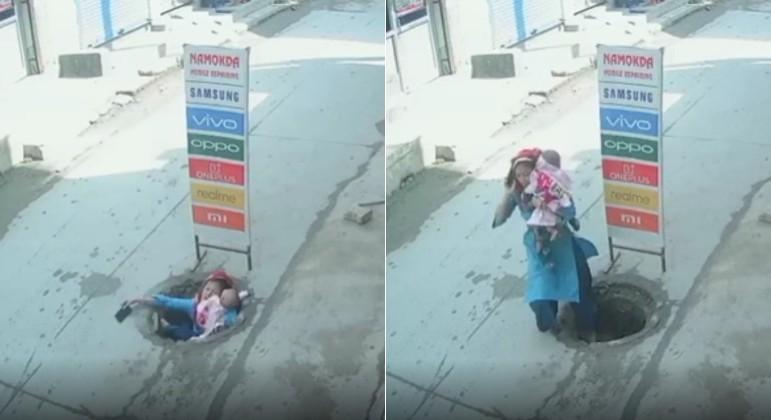 Distracted by phone, mother carrying baby falls into manhole