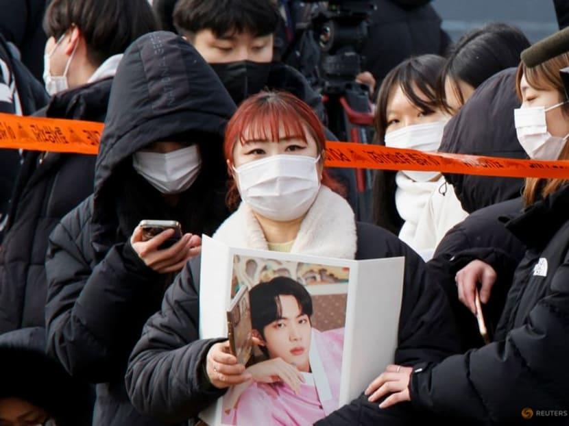 BTS megastar Jin begins military service amid tight security, cheering fans