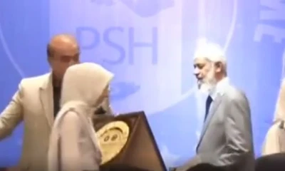 Dr Zakir Naik walks away from stage during an event in capital