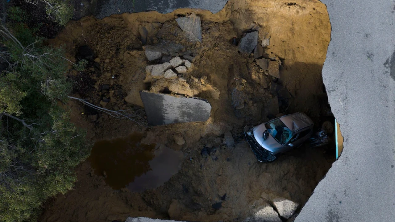 Giant sinkholes swallow cars as torrential rain batters California 