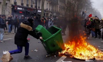 Embattled Macron heads to China, leaving burning Paris behind